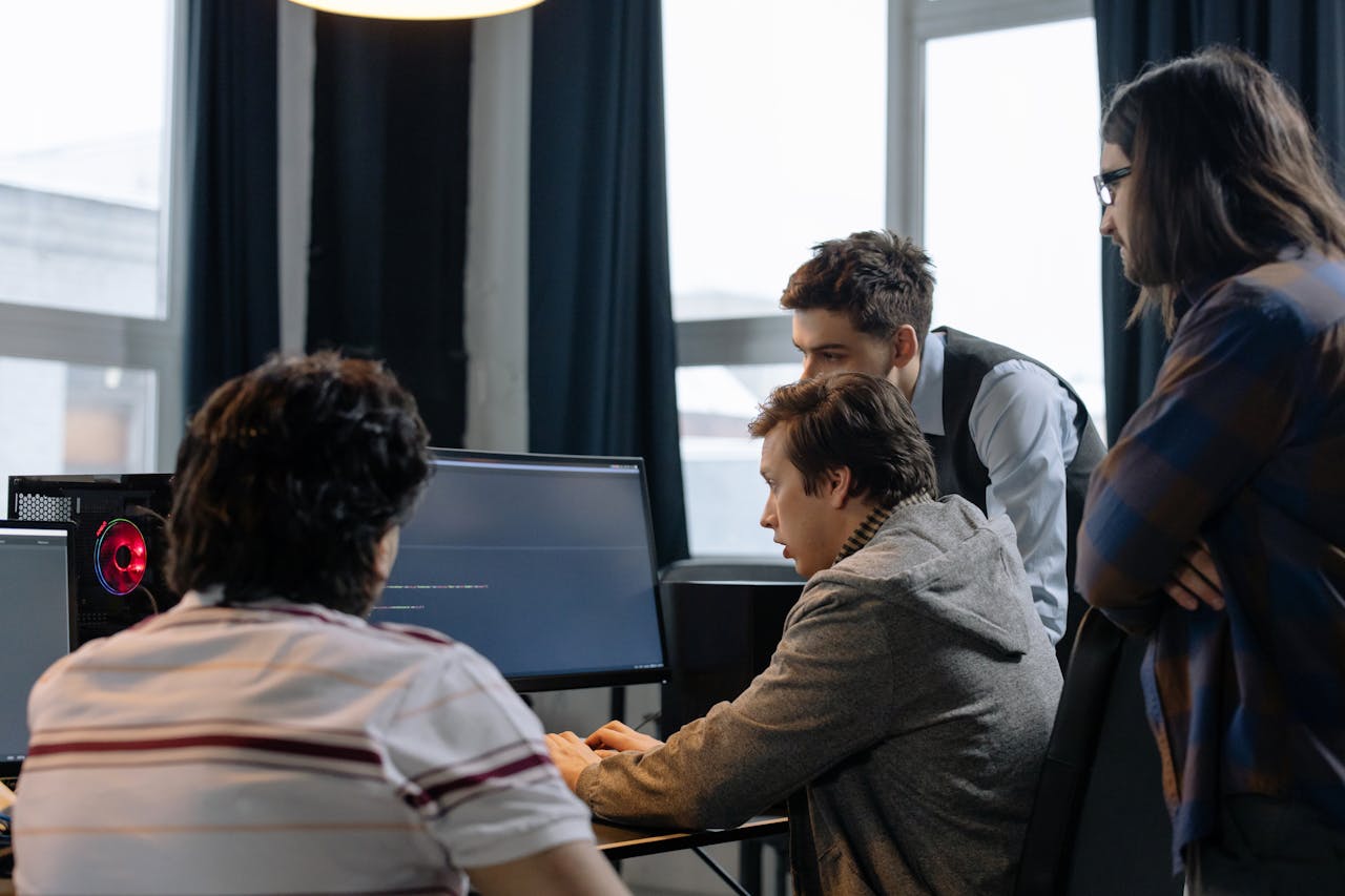 Home Group of developers working together on a computer programming project indoors.